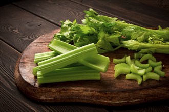 Fresh bunch of celery, top view, no people, on a dark background