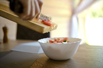 Close-up view of making juicy fresh organic vegetable salad