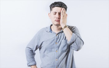 Exhausted person putting the palm of his hand on his face. Tired and exhausted man covering his