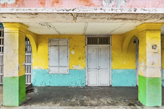 Closed, dilapidated building with peeled off house wall in pastel shades, pastel, green,