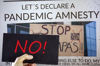 Symbolic image of Pandemic Amnesty: a section of a symbolic newspaper with a sign reading NO held