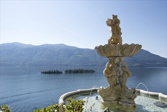 Fountain Statue with View Over Lake Maggiore with Brissago Islands and Mountain in a Sunny Day in