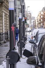 Winter in the city, electric cars charging at charging stations in the city centre of Frankfurt,