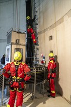 Height rescuers from the Oberhausen professional fire brigade practise abseiling from a wind