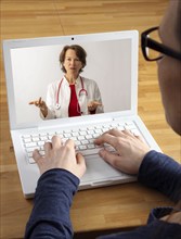 Symbolic image of telemedicine, patient speaking to a doctor in a video conference from home