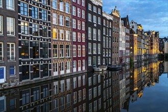 Canal houses on the Damrak, in the centre of the old town of Amsterdam, harbour, starting point of