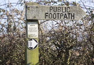 Close up wooden public footpath sign, no through route due to coastal erosion, River Deben,