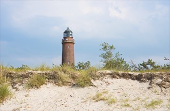 Lighthouse Darßer Ort behind dune with sparse vegetation, sand dune, Darsser Ort, cloudy sky,