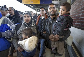 Syrian refugees arrive at Schönefeld station on a special train. They are then taken by bus to