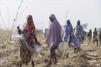 Women with buckets in Maraban Dare community in Plateau state, Nigeria, 07/02/2024. People are