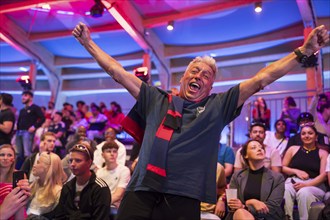 A fan of the British team celebrates the equaliser at the Adidas fan zone at the Bundestag during