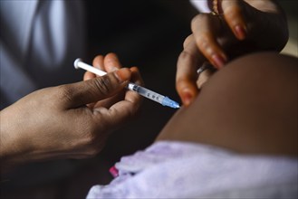 Beneficiaries receives dose of COVID-19 coronavirus vaccine in a vaccination centre at a village in