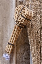 Carpet beater hanging in front of a shop for sale, Asciano, Tuscany, Italy, Europe