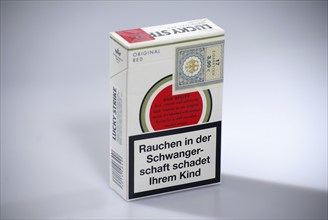 Cigarrette box Lucky Strike, back with tax band arole and warning Smoking during pregnancy harms