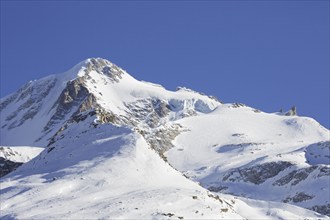 Snow covered mountaintop, pinnacle of the Gran Paradiso mountain in winter in the Gran Paradiso