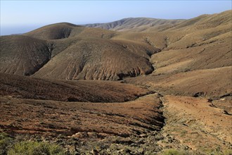 Bare moon-like arid landscape in mountains between Pajara and La Pared, Fuerteventura, Canary