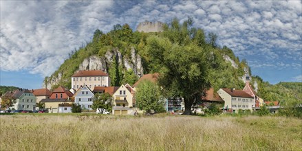 View of the small town of Kallmünz below the castle ruins looming on a limestone cliff and lively