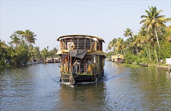 Traditional houseboat on a canal in the canal system of the backwaters, Kerala, India, Asia