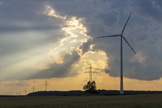 Wind farm, wind turbine, wind turbines, in front of sunset, storm clouds, overhead power lines, sun