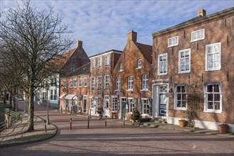 Historic brick houses at the old Siel, Greetsiel, Krummhörn, East Frisia, Lower Saxony, Germany,