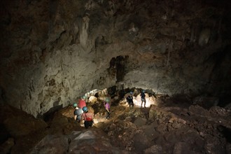 Visitors in a stalactite cave, Terciopelo Cave, Barra Honda National Park, Costa Rica, Central