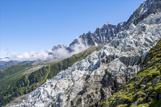 Glacier ice of the Glacier des Bossons, behind pointed mountain peaks, Chamonix, Haute-Savoie,