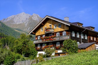 Farmhouse decorated with flowers. Burg district, Kals am Großglockner, East Tyrol, Austria, Europe