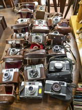 A collection of vintage cameras on display at auction, UK