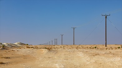 Power line runs through the Rub al Khali desert, Dhofar province, Arabian Peninsula, Sultanate of