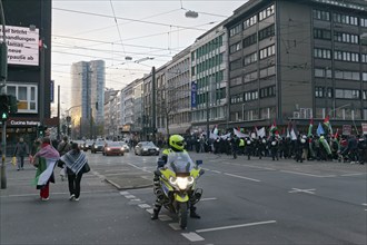 Demonstration procession on Berliner Allee, traffic policeman on motorbike, Pro Palestine