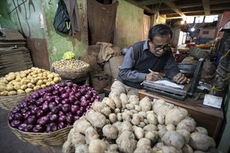 Vendor selling vegetables at a market, ahead of the presentation of the Interim Budget 2024 by