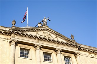 Union Jack flag flying with Britannia holding scales of Justice, top Guildhall building, Bath,