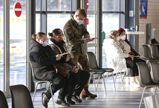 Vaccinees and a soldier of the German Armed Forces in the vaccination centre in Terminal 5 of BER