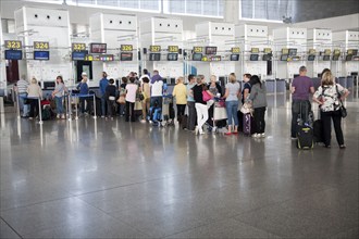 People waiting to check in inside Malaga airport, Spain, Europe