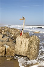 March 20 2018 Hemsby, UK. Coast path sign left abandoned by coastal erosion at Hemsby, Norfolk,