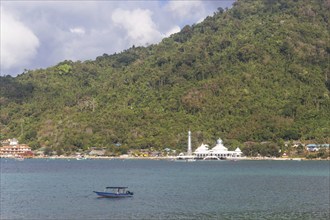 Green tropical island with a mosque on the coast.Malaysia