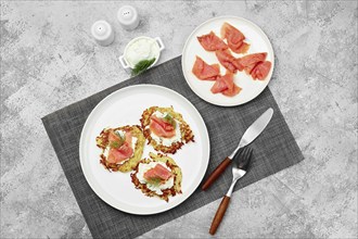 Top view of potato pancake with salmon and cream cheese