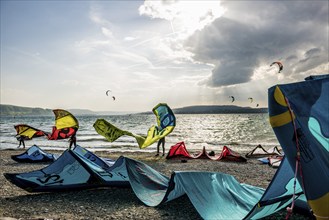 Kitesurfers and windsurfers in sun and storm, Reichenau Island, Untersee, Lake Constance,