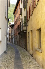 Beautiful Old Narrow Street with Old Building with Sunlight in Bissone, Ticino, Switzerland, Europe