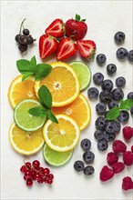 Mix of fruits and berries, set, assortment, sliced citrus fruits, raspberries, blueberries, mint