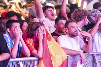 Fans of the Spanish team fear after the equalising goal by England at the Adidas fan zone at the