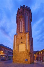 The brick Gothic Owl Tower, illuminated at night, in the old town centre of Tangermünde, Hanseatic