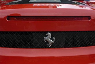 Close-up detail of red rear end of sports car Supercar Ferrari Spyder with logo trademark of luxury