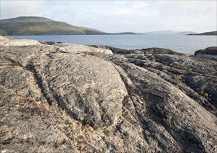 View to Sandray Island from rocky headland at Bagh a Deas, South Bay, Vatersay island, Barra, Outer