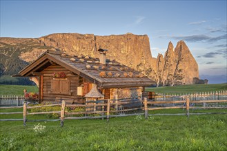 Alpine hut in front of Schlern, sunrise, blue sky, Seiser Alm, Dolomites, South Tyrol