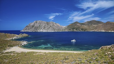 Breathtaking bay with turquoise water, a boat and mountains under a clear sky, Psili Ammos Srand,