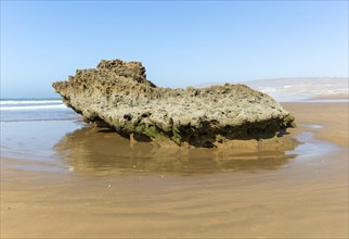 Rocky outcrop on sandy beach at Taghazout, Morocco, North Africa, Africa