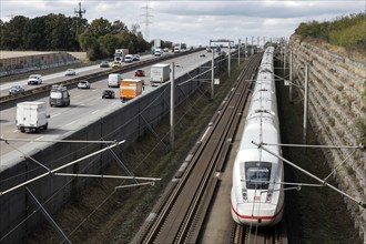 A Deutsche Bahn ICE train passes cars on the A3 motorway, Flörsheim, 28/09/2020