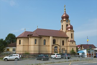 A church with a yellow exterior and a golden domed roof under a clear blue sky, Orthodox Church,