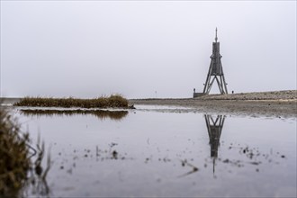 Thick fog in winter, hangs over the mouth of the Elbe into the North Sea, navigation mark and